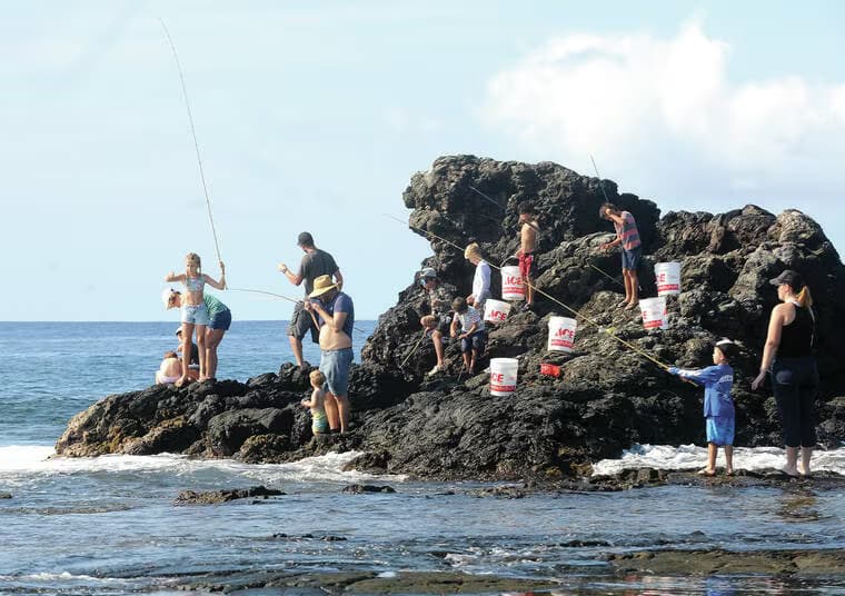 Keiki fishing with bamboo poles at the Keiki of Da Aina Foundation's annual bamboo fishing tournament at Old Kona Airport Park