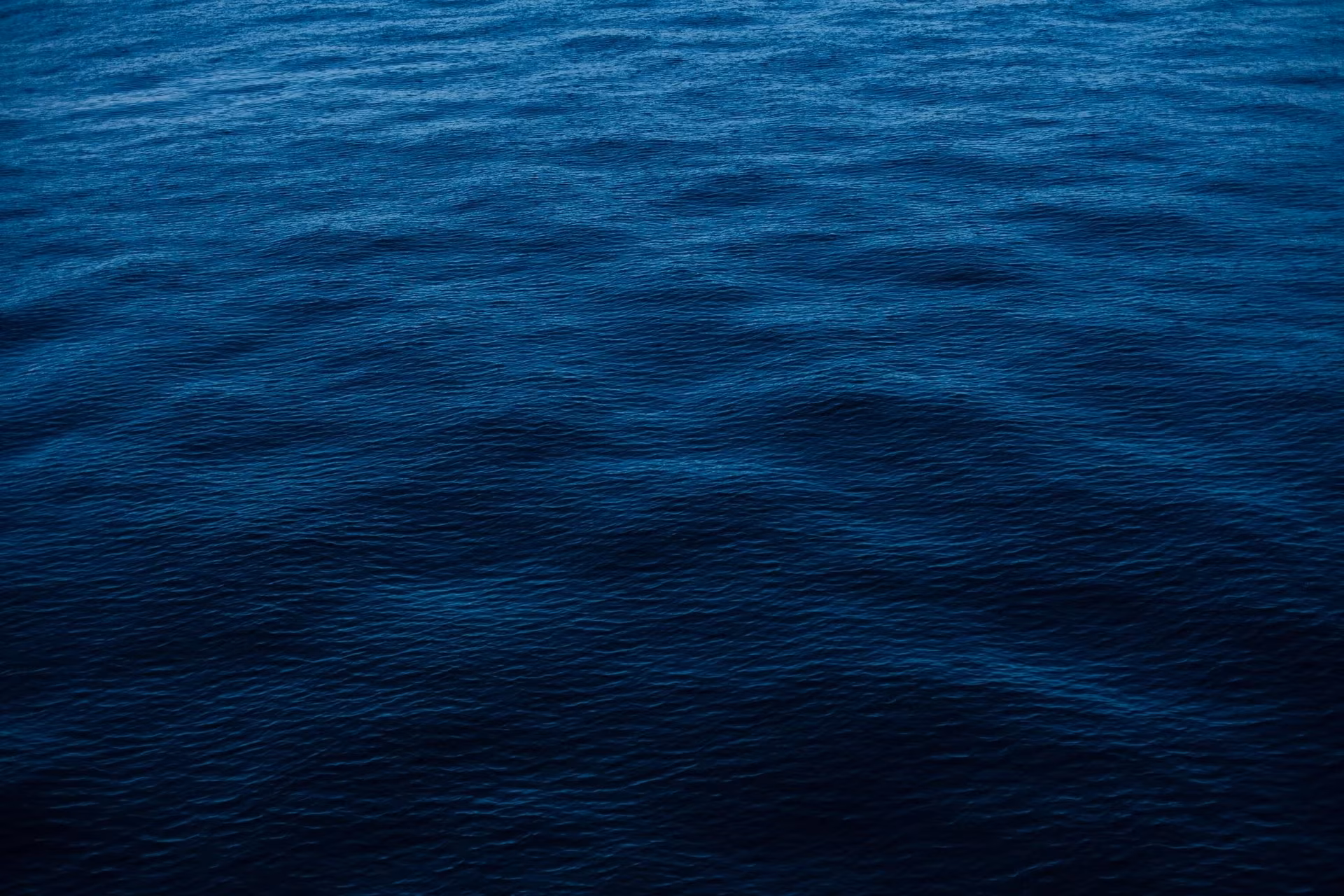 Deep blue Kona coastline at sunset